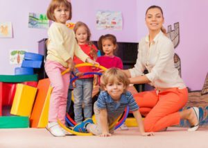 Kindergarten-teacher-playing-with-children-Stock-Photo-02-1-300×213